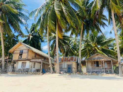 
a beach with palm trees and palm trees at Castaway Beach Bungalows in Hinkong
