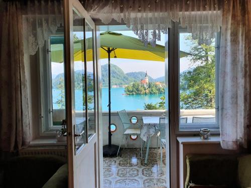 a view of a lake from a room with an umbrella at Sovica in Bled