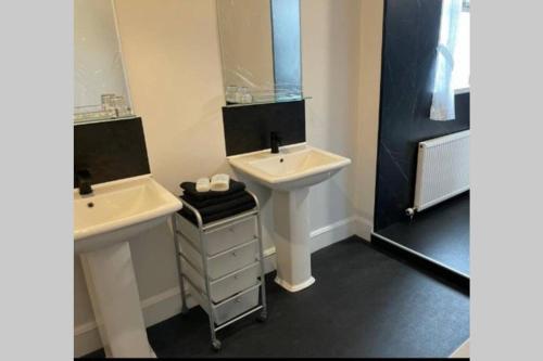 a bathroom with a sink and a mirror at Preston Villa, spacious ground floor apartment in Buckie