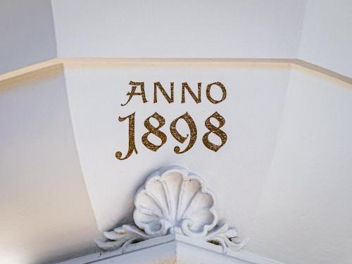 a clock with the numeral amino on it at Villa Rein Boutiquehotel in Bad Reichenhall