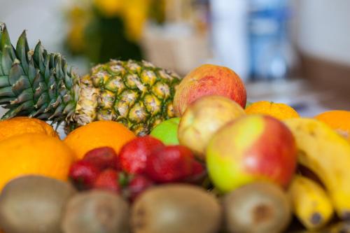 a pile of different types of fruits on a table at Centro Hotel U-NO1, Trademark Collection by Wyndham in Großbettlingen
