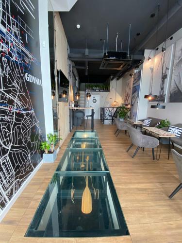 a lobby with a glass pool in the middle of a room at Thruster - mini kino, lobby, kuchnia, netflix in Gdynia
