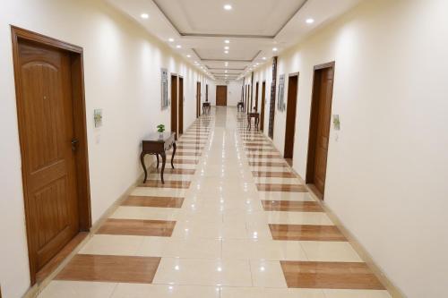 a hallway of a building with a long corridor at Grand Millennium Hotel in Lahore