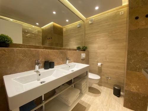 a bathroom with a sink and a toilet at Shell Sky Luxury Penthouse with Private Pool in Zadar