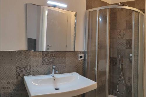 a bathroom with a sink and a shower with a mirror at LaCasetta in Saint Vincent