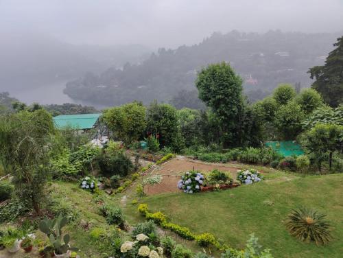 a garden with flowers and plants in a field at Narayana Lake Hide Out in Bhīm Tāl