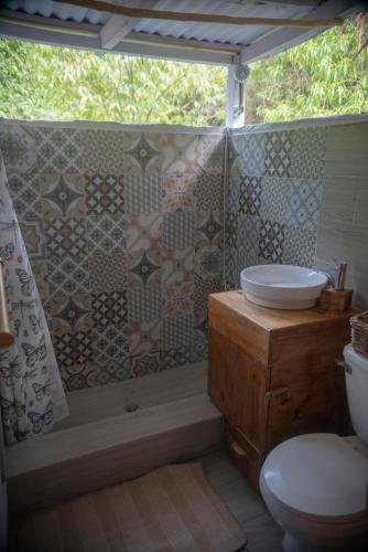a bathroom with a sink and a toilet and a shower at Aventura Rincon Ecolodge in Las Galeras