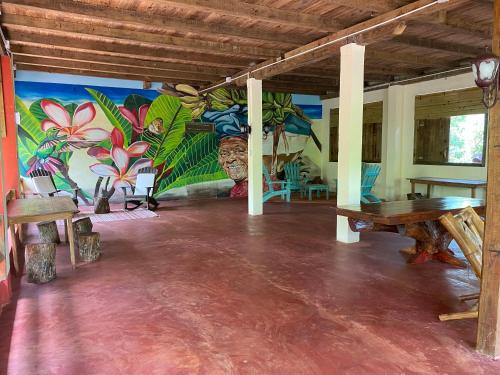 a room with a table and a mural on the wall at Aventura Rincon Ecolodge in Las Galeras