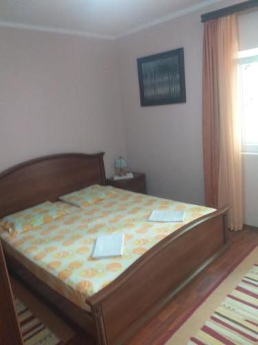 a bedroom with a bed in a room at Guesthouse Djacic in Budva