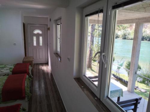 a room with a bed and a window with a view at Apartman na Drini in Foča