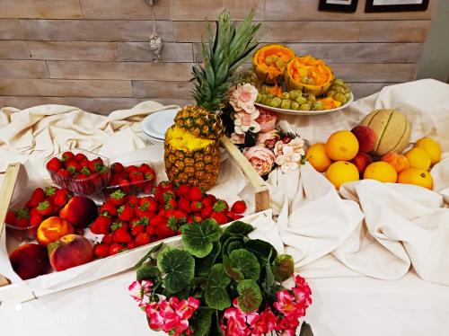 a bunch of fruits and vegetables on a table at Hotel Garisenda B&B - in Centro a Riccione - in Riccione