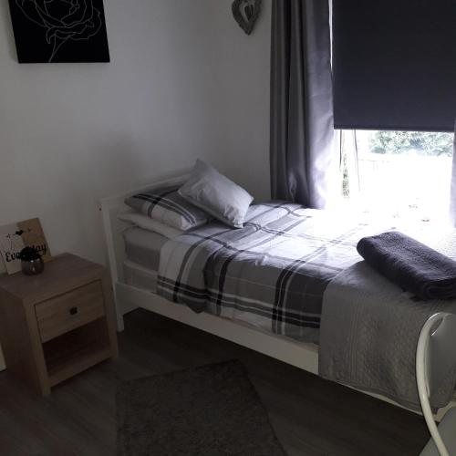 a small bedroom with a bed and a window at Blaney house 21 in Newcastle upon Tyne