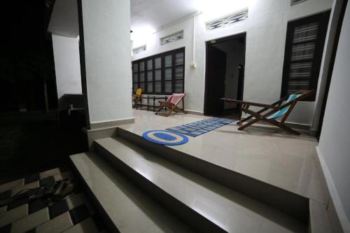 a view of a house with a chair and a rug at Aqualillies Water Front Heritage Homestay in Kumarakom