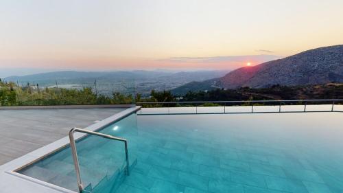 a swimming pool with a view of the mountains at Valeni Boutique Hotel & Spa in Portariá