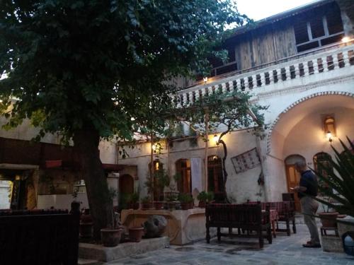 a man standing in front of a building at ŞarkÇırağan Konak Boutique Hotel in Sanlıurfa