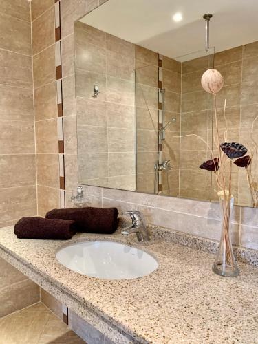 a bathroom with a sink and a mirror at Luxury Apartment Pirin Chalet in Terra Complex in Bansko