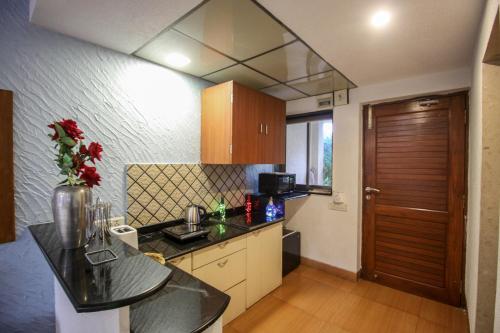 a kitchen with a sink and a counter top at EKO STAY - Tropical Beach Apartments in Mumbai