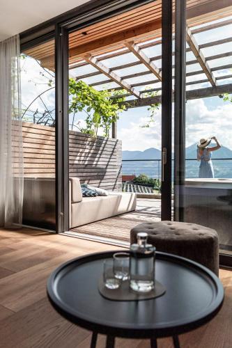 a coffee table in a room with a view of the ocean at Boutique Hotel Eschenlohe in Schenna