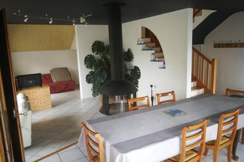 une salle à manger avec une table et une cheminée dans l'établissement Agréable maison entre plage (900m) et forêt (600m), à Saint-Cast-le-Guildo