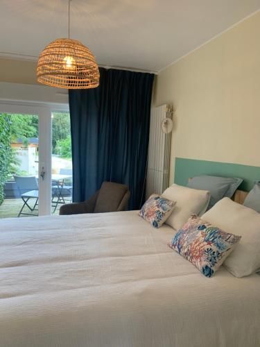 a bedroom with a large bed with two pillows at Chambres des marais in Merville-Franceville-Plage