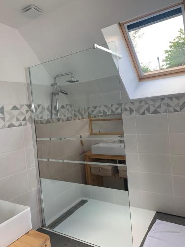 a bathroom with a shower and a sink at Chambres des marais in Merville-Franceville-Plage
