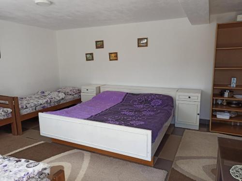 a bedroom with two beds with purple sheets at The Lakes Lagoon in Plav