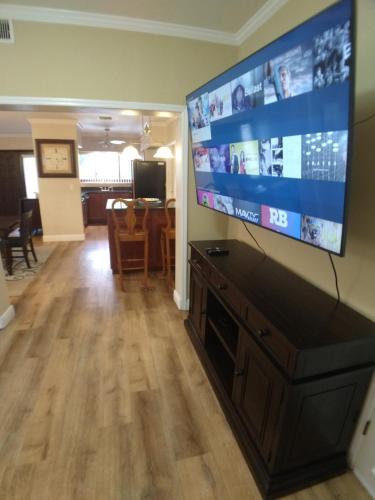 a living room with a large flat screen tv on a wall at PERFECT BEACH GETAWAY for 6-10 in Satellite Beach