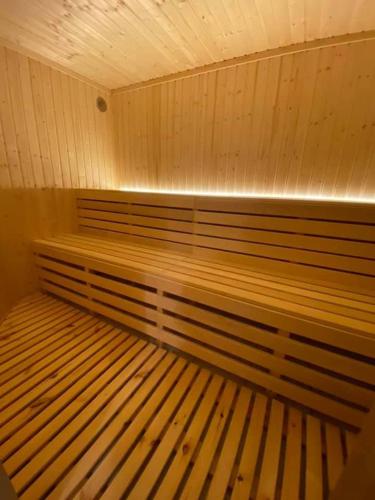a room with a wooden bench in a sauna at Kadyny Folwark Hotel & SPA in Kadyny