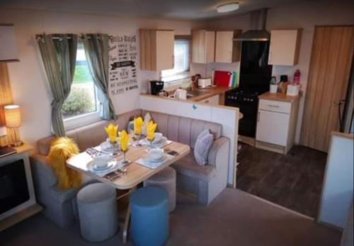 a small kitchen with a table in a caravan at Tattershall Lakes Family Holiday Hot Tub break in Tattershall