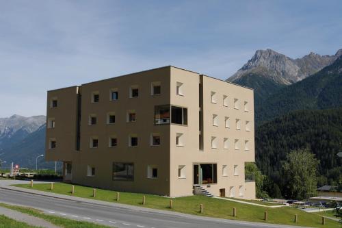 a building on the side of a road at Scuol Youth Hostel in Scuol