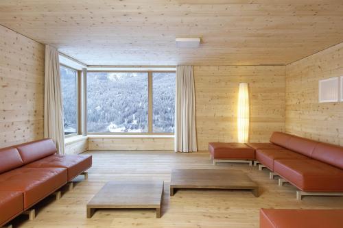 a living room filled with furniture and a fire place at Scuol Youth Hostel in Scuol