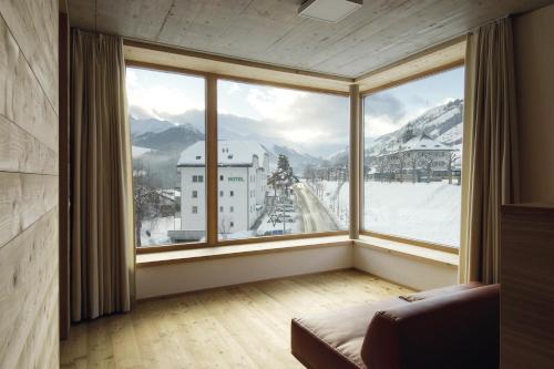 a large window with a view of a snowy mountain at Scuol Youth Hostel in Scuol