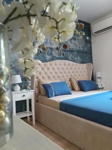 a bedroom with a large bed with blue pillows at Sandanski Apartments Top Center in Sandanski
