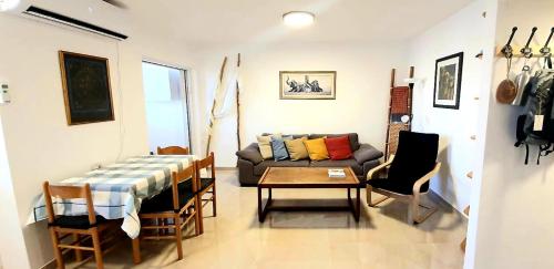 a living room with a couch and a table at Crater Zen in Mitzpe Ramon