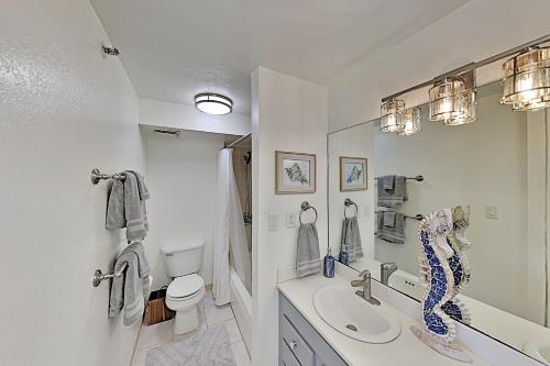 a white bathroom with a sink and a toilet at Hawaiian Monarch 203 condo in Honolulu