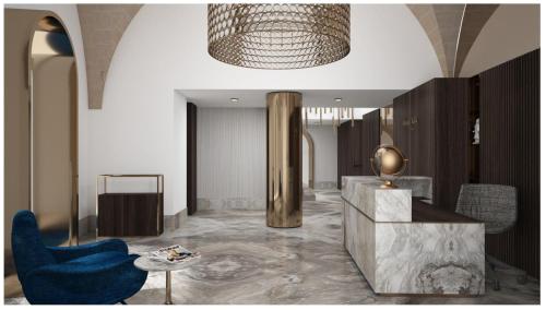 a lobby with a blue chair and a table at Albergo Italia in Matera