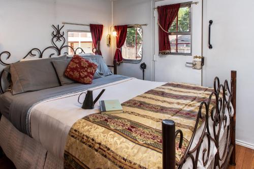 a bedroom with a large bed with a blanket at Woodrow House Bed & Breakfast in Lubbock