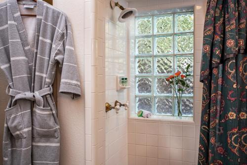 a bathroom with a shower and a window at Woodrow House Bed & Breakfast in Lubbock
