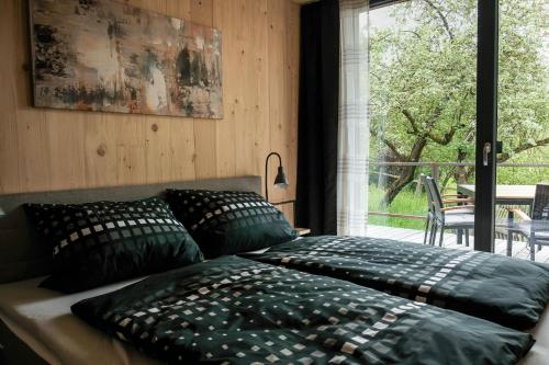 a bedroom with two pillows on a bed and a window at Ferienhaus erholzeit. in Wettringen