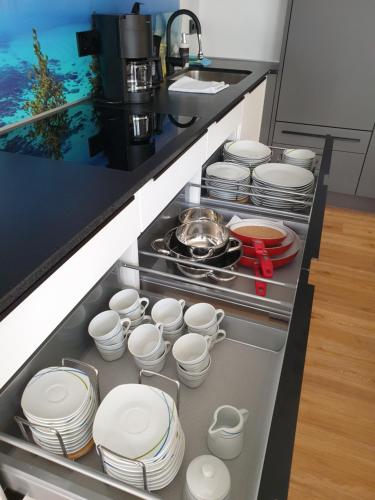 a kitchen with white dishes in a drawer at Golf & Ski Appartements Mittersill Trausmuth Monika inkl Sommercard - Golfplatz 500 m entfernt, inkl Waschmaschine, Trockner in Mittersill