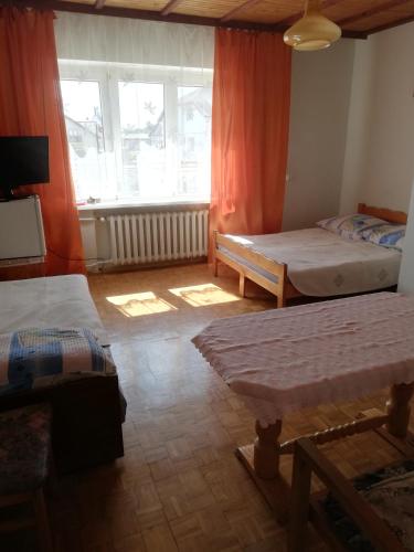 a room with two beds and a window at U Halinki in Darłowo