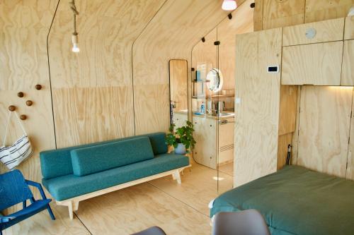 a living room with a couch and a bed at Wikkelboats at Tramkade Den Bosch in Orthen