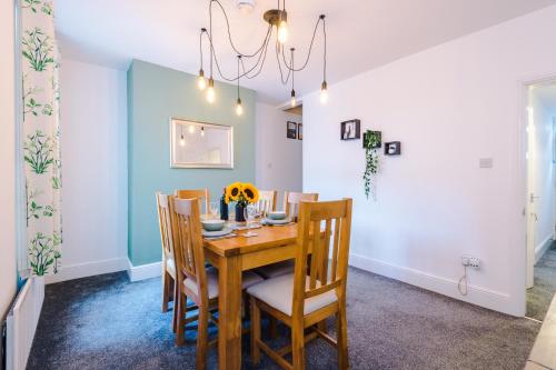 a dining room with a wooden table and chairs at Spacious 2-Bed City-Centre Cottage in Chester by 53 Degrees Property - Ideal for Groups & Couples - Sleeps 6 in Chester