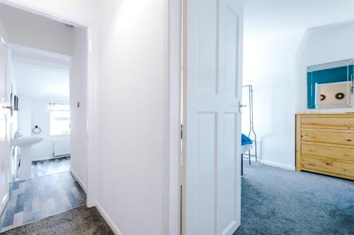 a room with a closet and a wooden dresser at Spacious 2-Bed City-Centre Cottage in Chester by 53 Degrees Property - Ideal for Groups & Couples - Sleeps 6 in Chester