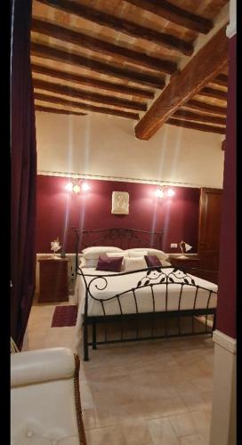 a bedroom with a bed and a red wall at B&B SERENA in Perugia