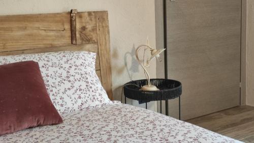 a bed with a red pillow and a night stand next to it at La Terra Buona guest house in Villa San Secondo