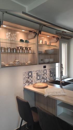 a kitchen with a counter and chairs in a room at La Terra Buona guest house in Villa San Secondo