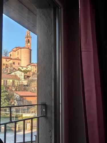 a window with a view of a church at La Terra Buona guest house in Villa San Secondo