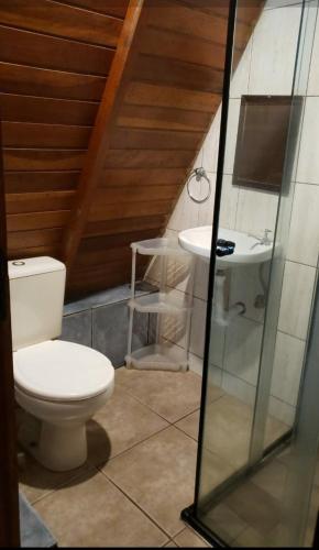 a bathroom with a toilet and a sink at Chalès em Ilhabela Litoral Norte in Ilhabela