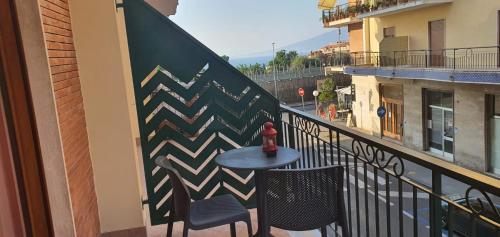 a balcony with a table and two chairs and a fire hydrant at The White Lodge in Sorrento